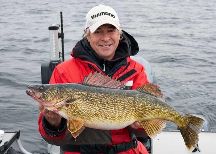 angler holding large walleye