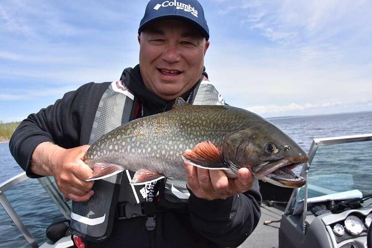 angler with brook trout