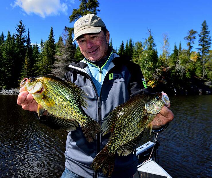 angler holding black crappie