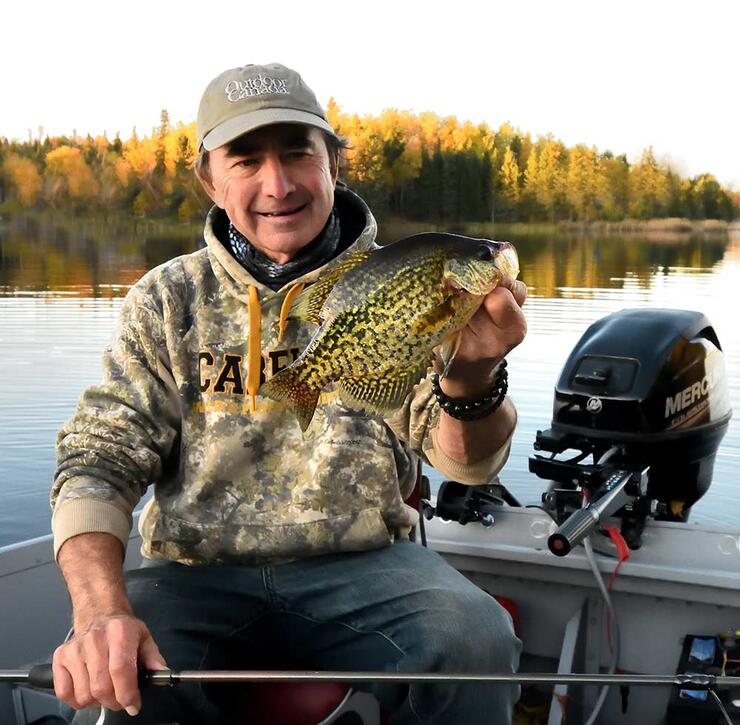 angler holding black crappie