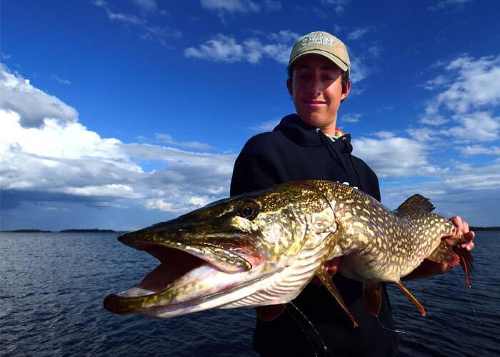 young angler holding ontario northern pike