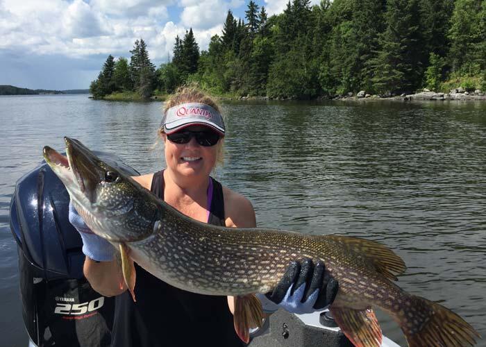 woman angler holding an ontario northern pike