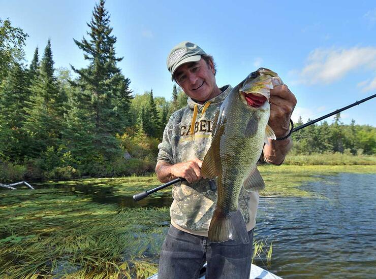 angler holding ontario largemouth bass