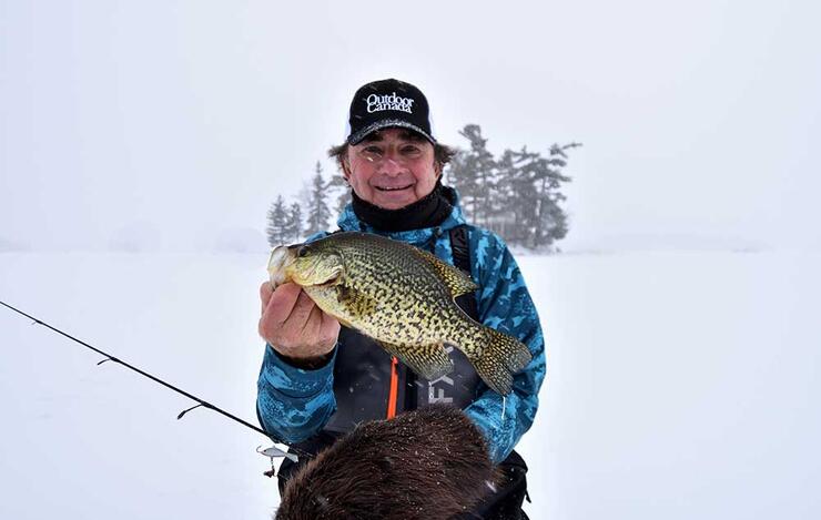 angler ice fishing black crappie