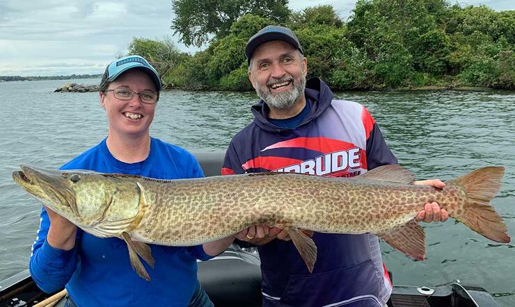anglers holding large fish
