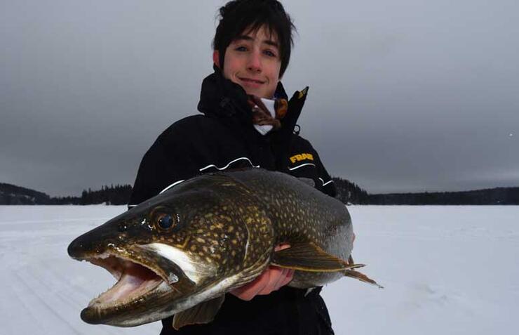 ice angler with lake trout