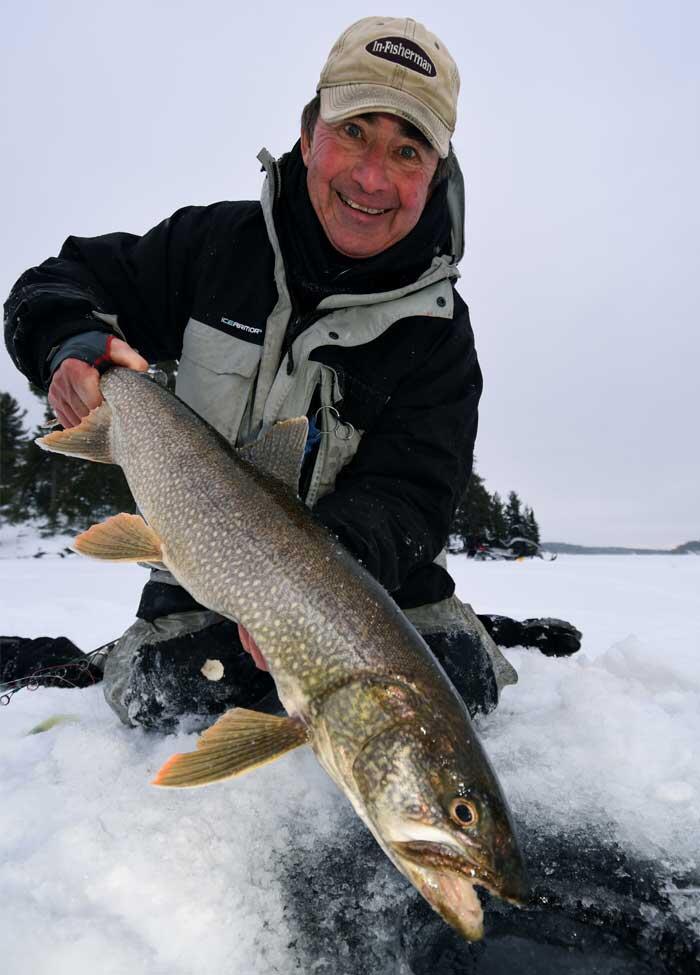 ice angler holding lake trout
