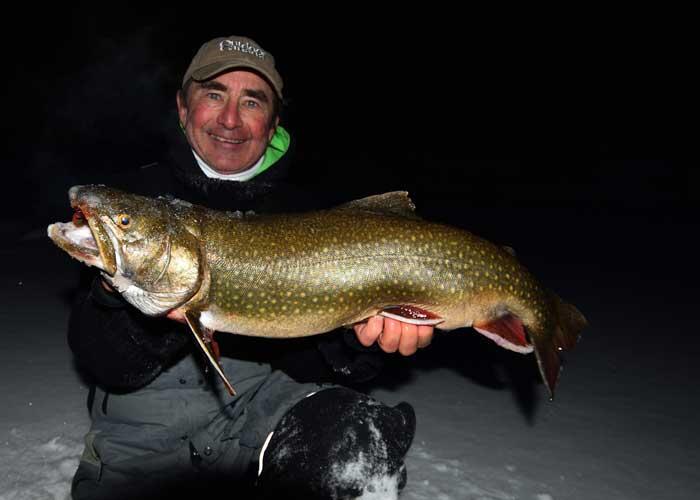 ice angler holding lake trout