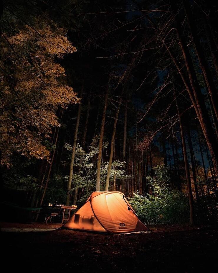 Tent aglow on campsite at night