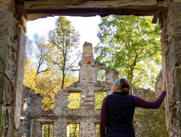 Woman standing at entrance to ruins