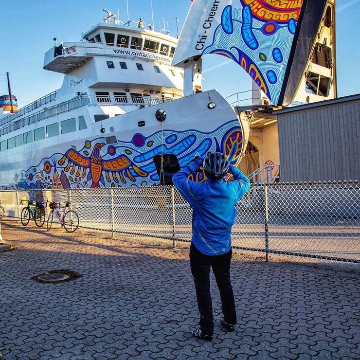 Cyclists taking picture of ferry