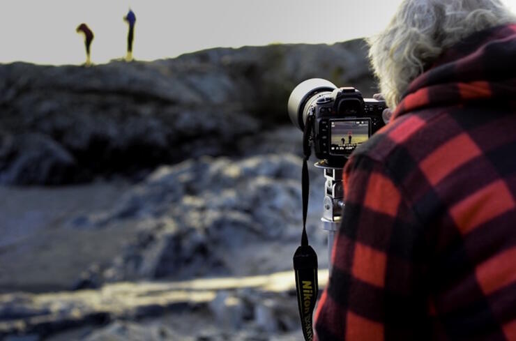 Back of person taking a photo of rocks