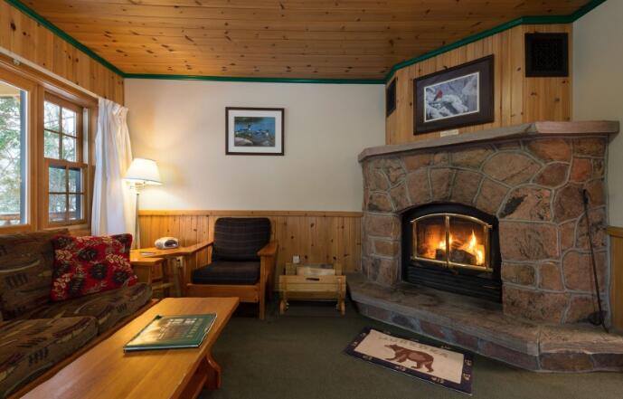 inside a cozy cabin with a wood burning fireplace